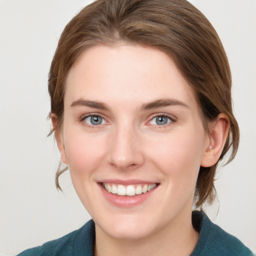 Joyful white young-adult female with medium  brown hair and blue eyes