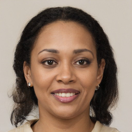 Joyful black young-adult female with medium  brown hair and brown eyes