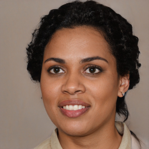 Joyful black young-adult female with medium  black hair and brown eyes