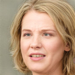 Joyful white adult female with medium  brown hair and green eyes