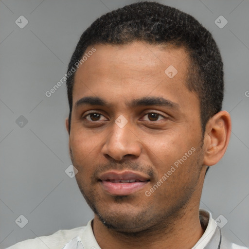 Joyful black young-adult male with short  black hair and brown eyes