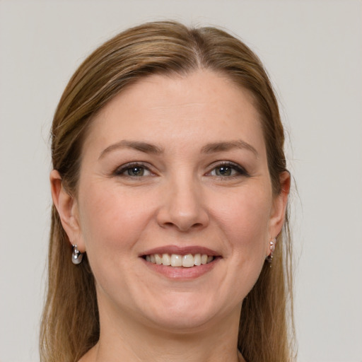 Joyful white adult female with long  brown hair and grey eyes