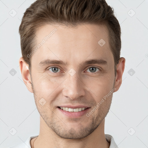 Joyful white young-adult male with short  brown hair and grey eyes