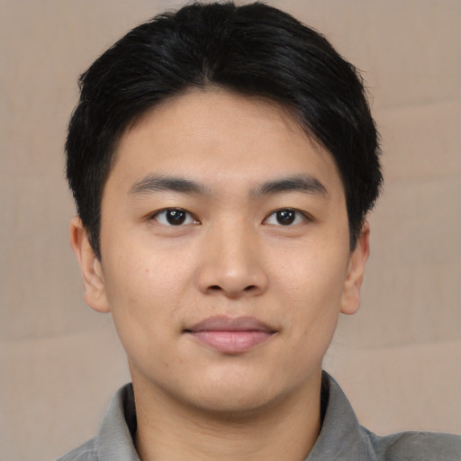 Joyful asian young-adult male with short  black hair and brown eyes