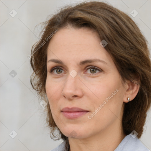 Joyful white adult female with medium  brown hair and green eyes