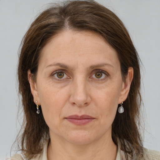 Joyful white adult female with medium  brown hair and grey eyes