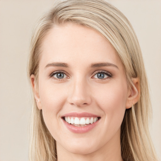 Joyful white young-adult female with long  brown hair and blue eyes