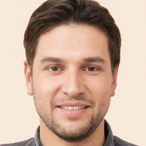 Joyful white young-adult male with short  brown hair and brown eyes