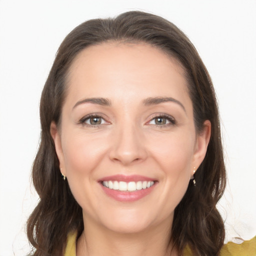 Joyful white young-adult female with long  brown hair and brown eyes