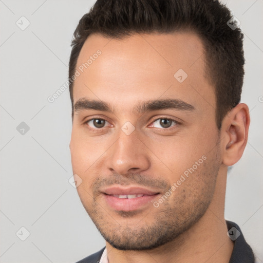 Joyful white young-adult male with short  brown hair and brown eyes