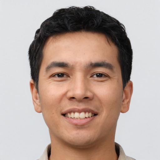 Joyful asian young-adult male with short  brown hair and brown eyes