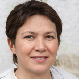 Joyful white adult female with short  brown hair and brown eyes