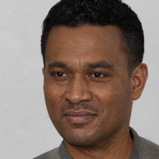 Neutral black adult male with short  black hair and brown eyes