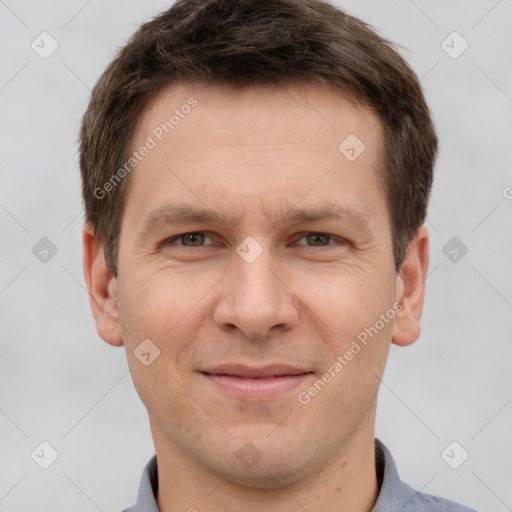 Joyful white adult male with short  brown hair and grey eyes