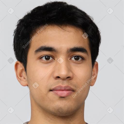 Joyful latino young-adult male with short  brown hair and brown eyes