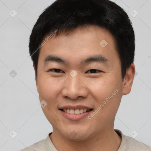 Joyful asian young-adult male with short  black hair and brown eyes