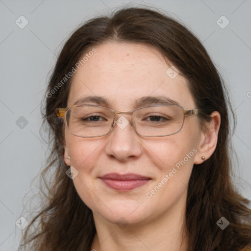 Joyful white adult female with long  brown hair and grey eyes