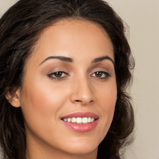 Joyful white young-adult female with long  brown hair and brown eyes