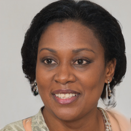 Joyful black adult female with medium  brown hair and brown eyes