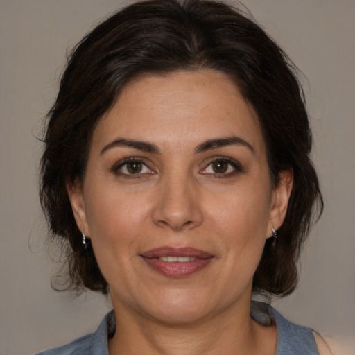 Joyful white adult female with medium  brown hair and brown eyes