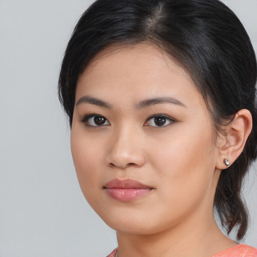 Joyful asian young-adult female with medium  brown hair and brown eyes