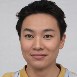 Joyful asian young-adult male with short  black hair and brown eyes