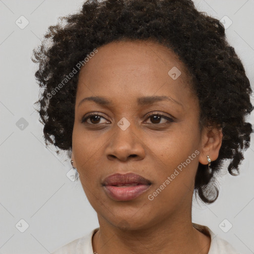 Joyful black adult female with medium  brown hair and brown eyes