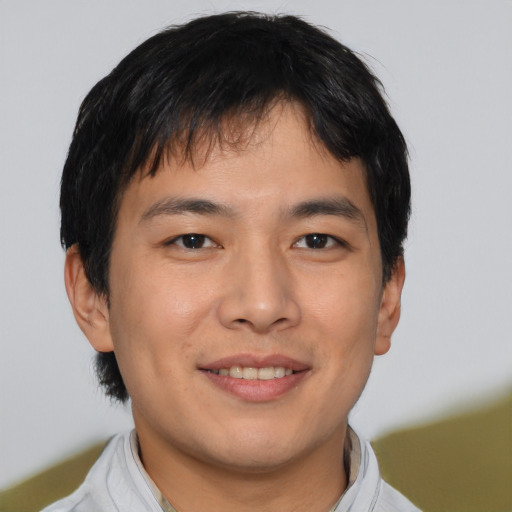 Joyful asian young-adult male with short  black hair and brown eyes