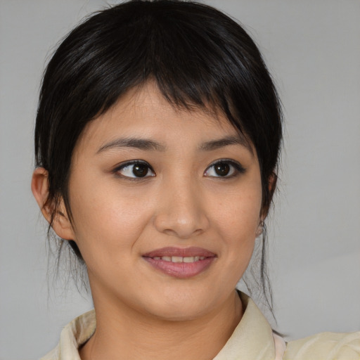 Joyful asian young-adult female with medium  brown hair and brown eyes