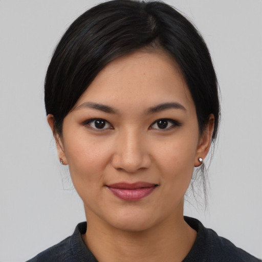 Joyful latino young-adult female with medium  black hair and brown eyes