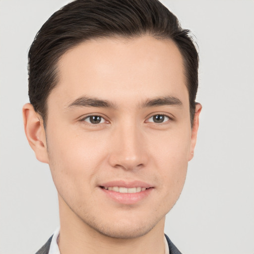 Joyful white young-adult male with short  brown hair and brown eyes