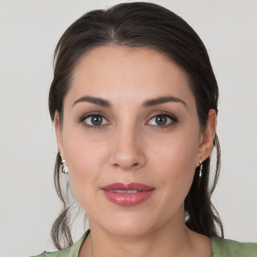 Joyful white young-adult female with medium  brown hair and brown eyes