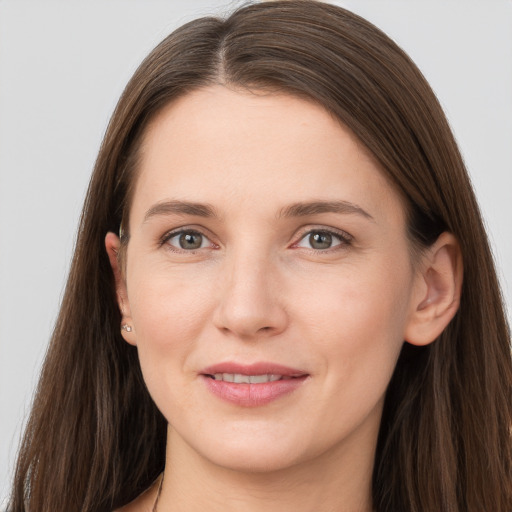 Joyful white young-adult female with long  brown hair and grey eyes