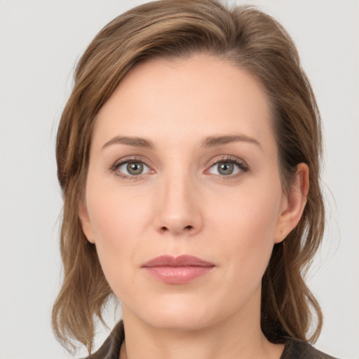 Joyful white young-adult female with medium  brown hair and grey eyes