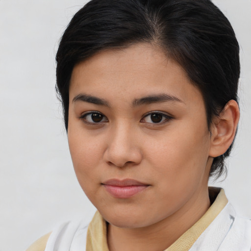 Joyful asian young-adult female with short  brown hair and brown eyes