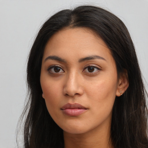 Neutral latino young-adult female with long  brown hair and brown eyes
