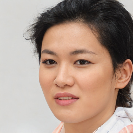Joyful asian young-adult female with medium  brown hair and brown eyes