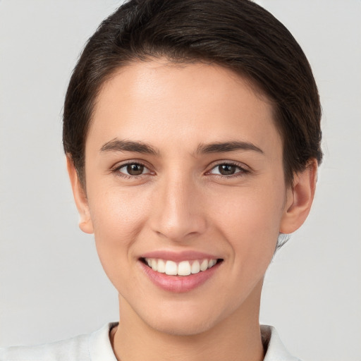 Joyful white young-adult female with short  brown hair and brown eyes