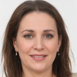 Joyful white adult female with long  brown hair and grey eyes