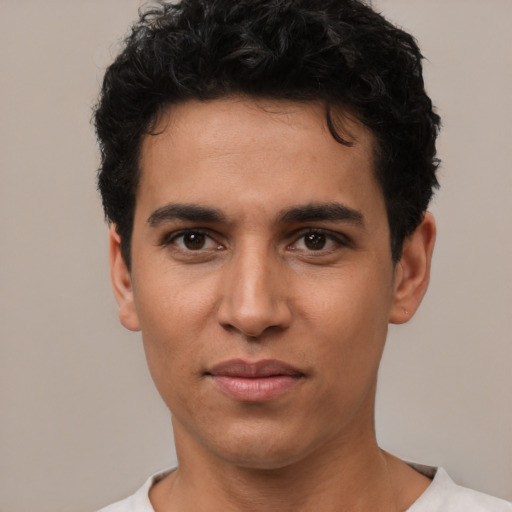 Joyful white young-adult male with short  black hair and brown eyes