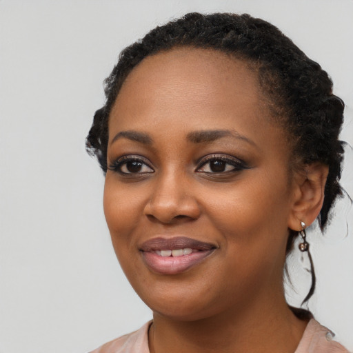 Joyful black young-adult female with medium  black hair and brown eyes