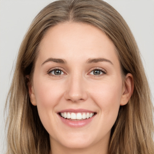 Joyful white young-adult female with long  brown hair and grey eyes