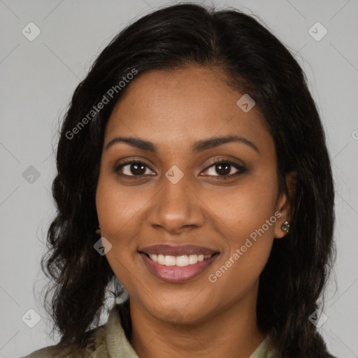 Joyful black young-adult female with long  brown hair and brown eyes