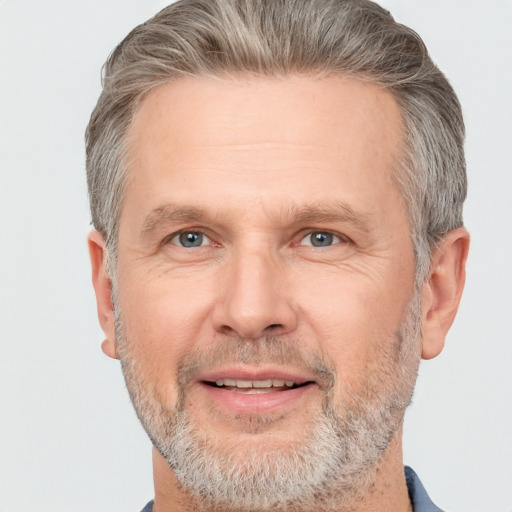 Joyful white middle-aged male with short  gray hair and brown eyes