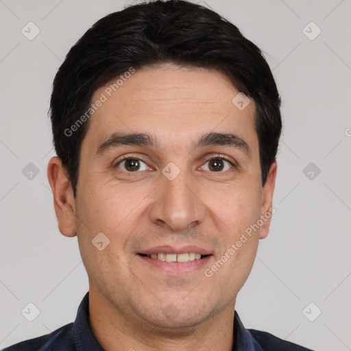 Joyful white young-adult male with short  black hair and brown eyes