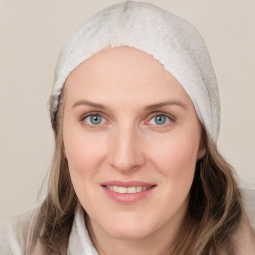 Joyful white young-adult female with medium  brown hair and blue eyes