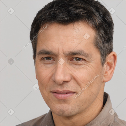 Joyful white adult male with short  brown hair and brown eyes