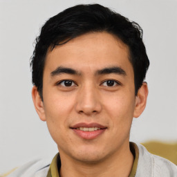 Joyful asian young-adult male with short  black hair and brown eyes