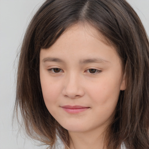 Joyful white child female with long  brown hair and brown eyes