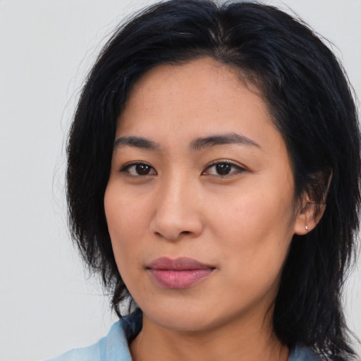 Joyful asian young-adult female with medium  black hair and brown eyes